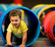 Fitness Fun for Tots (toddler crawling through a tunnel)