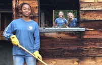 Three Youth Corps members smiling and working
