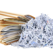 File folders next to a pile of shredded paper