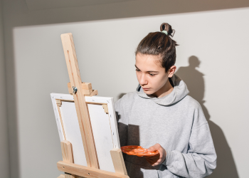 Teen painting on a canvas