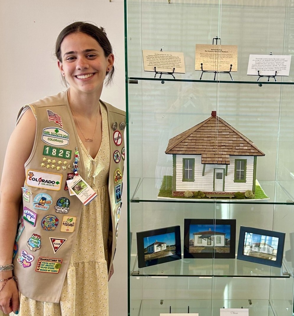 Ella standing next to her completed project