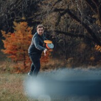 Man throwing disc in beautiful fall weather