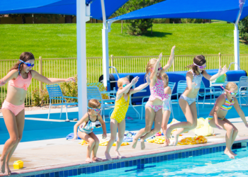Six girls jumping into the pool
