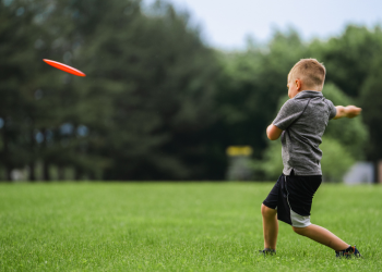 Young boy tossing an Ultimate Frisbee