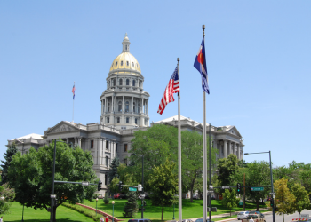 Colorado State Capitol building gold dome against a blue sky