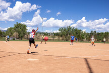 Child kicks ball during the 4th of July kickball championships game