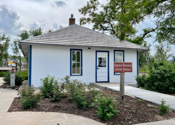 The Bungalow at Grasso Park with a fresh coat of white paint with blue trim.