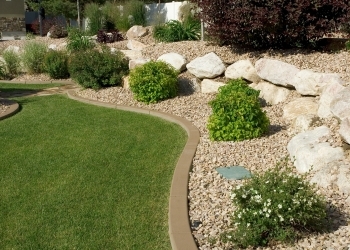 Landscaping including decorative rock and firewise plants.