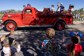 Superior historical firetruck with members of the historical commission riding the back