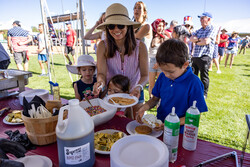 People building a pancake during the 4th Pancake Festival