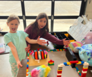 Superior youth showing off their Lego creation at a Snapology camp