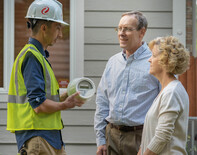 Person showing a smart meter to Xcel customers