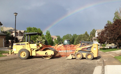 Rainbow over active road construction zone