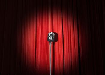 Microphone in front of a red curtain
