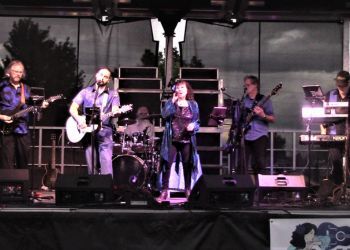 Members of Blu Rose Dance Band perform on stage.