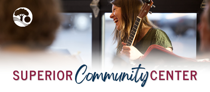 Alyna Waters smiles and plays her ukulele during the Superior Community Center ukulele jam