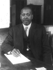 Black and white photo of O.T. Jackson in his capacity as advisor to Colorado governors signing a document.