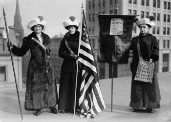 Black and white photo of suffragettes advocate for women's rights.