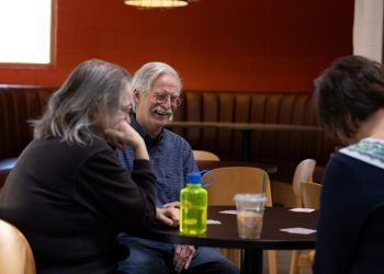 A man laughs during a euchre game at the Superior Community Center