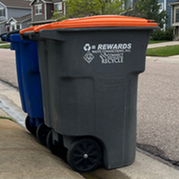 Two trash cans by the curb in a Superior neighborhood.