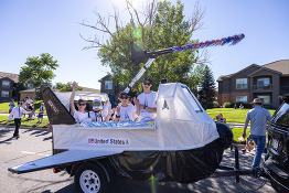 Children on a spaceship themed float during the 2022 4th of July parade.