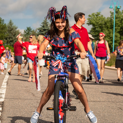 Child on a bike in the 2019 4th of July parade.