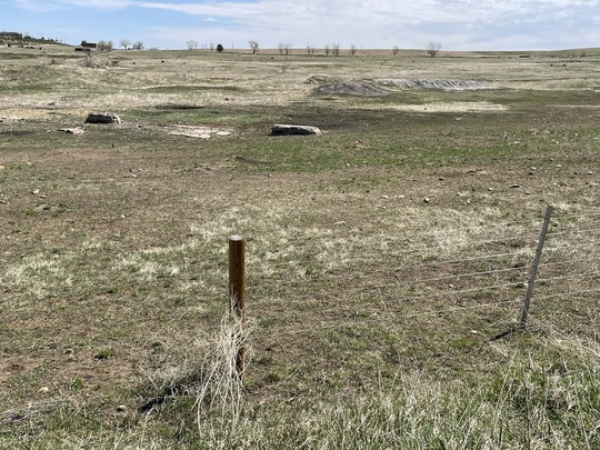 Small dark stains in the ground mark the old Mine Dump.