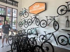 Seth Murray posing with bikes in Colorado Carbon Bicycles in Downtown Superior