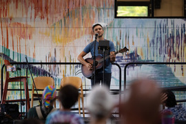 Person performing at Open Mic Night at the Superior Community Center