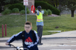 A crossing guard directs traffic at Eldorado PK-8