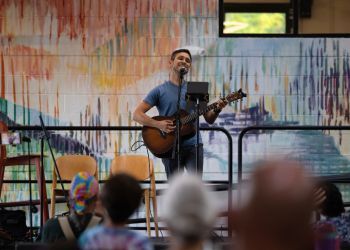 Person performing to crowd at Open Mic Night