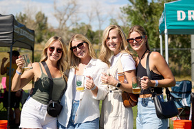 People pose with beer mugs at the 2023 Chili & Beer Fest