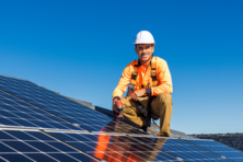 Contractor installing solar panels on a roof.