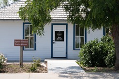 The interim historical museum with a closed sign on the front door.