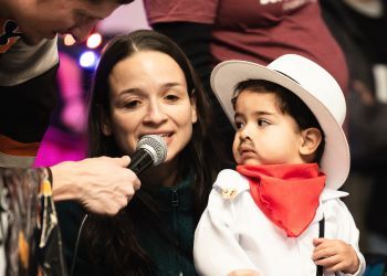 Mother and child speaking into a microphone at Monster Mash