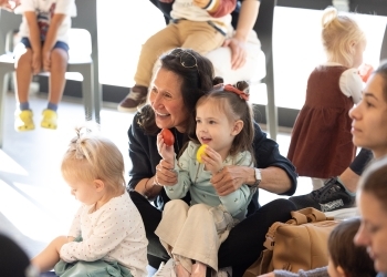 Mother and daughter smiling at family storytime