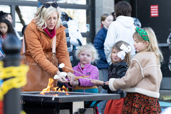 A group toasts marshmallows at the Winter Fest