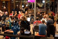 Residents sit in a circle and participate in the Holiday Sing-Along