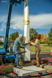 The artist and Town staff work to install Silencio on Rock Creek Parkway