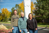 CAPS Chair Andrew Vaughan, artist Mike Clapper and Jennifer "JG" Garner pose in front of the statue
