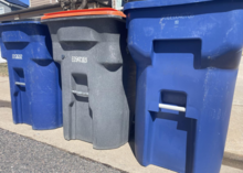 Three waste collection bins side-by-side