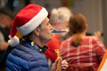 A man plays the kazoo at the Holiday Sing Along