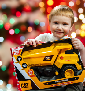 A child holds a toy donated through A Precious Child Precious Gift Drive