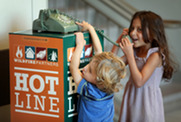 Two kids use the HOTline telephone
