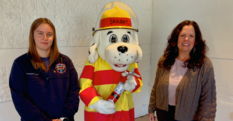Anna Christianson and Allison James pose with Sparky the fire safety dog