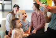 Children participating in family story time