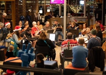 Residents sitting in a circle at holiday sing along