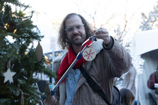 A person hangs an ornament at Winter Festival
