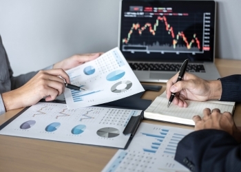 People looking at investing materials