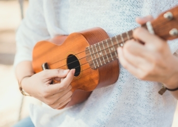 Person playing a ukulele